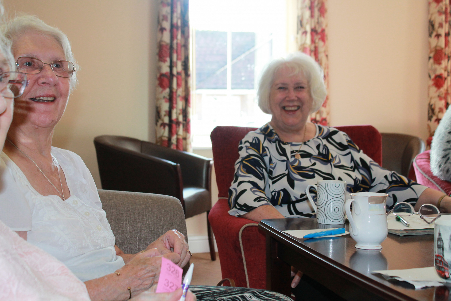Senior man greeting male care worker making home visit
